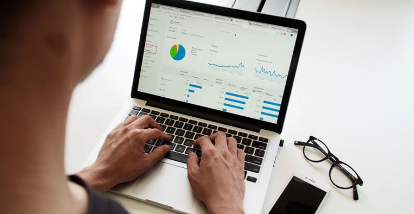 Person analysing marketing data and analytics on a laptop
