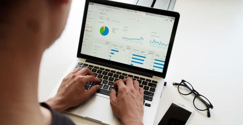 Person analysing marketing data and analytics on a laptop
