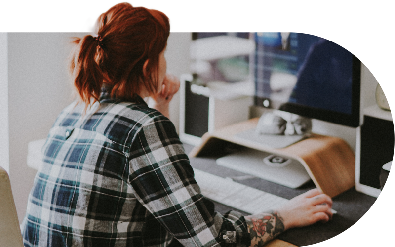 Woman working at a computer in a creative studio environment